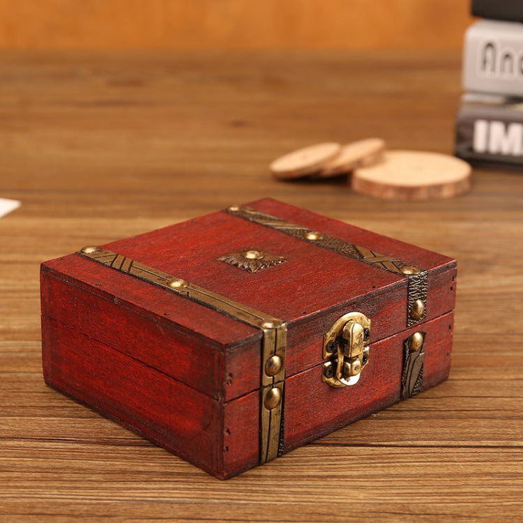 Red wooden jewelry box with brass lid clasp and decorative strap details