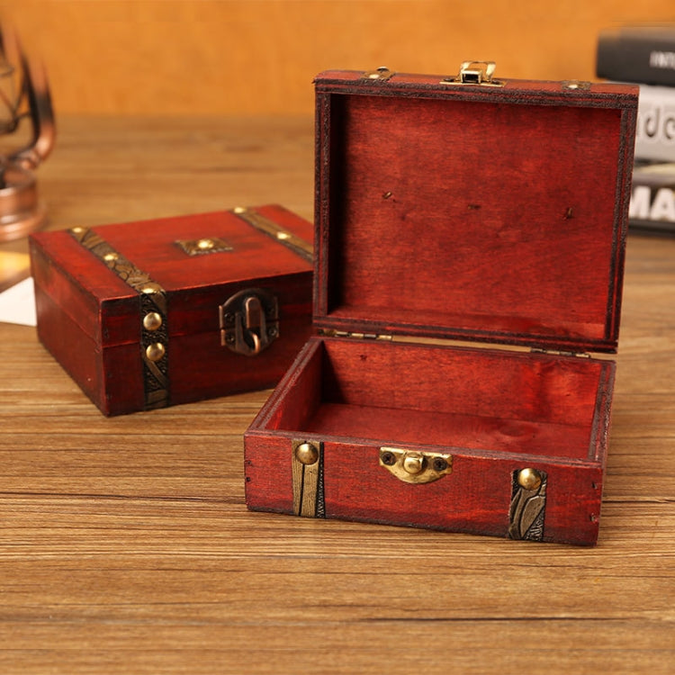 Open red wooden jewelry box with brass latch and empty interior