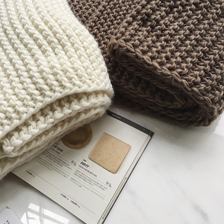 Close-up of chunky knitted wool scarves: white and dark brown, ribbed thick weave