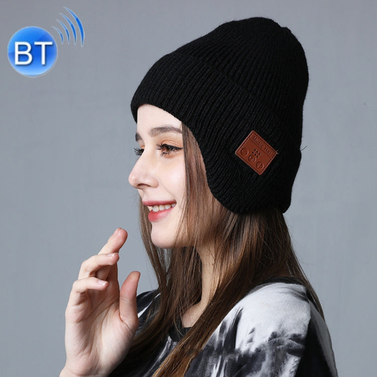 Black knit Bluetooth music hat with ear-covered design and brown control patch