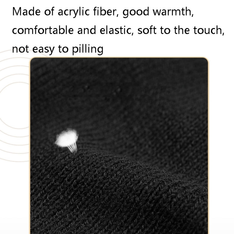 Black ribbed knit hat fabric close-up with small white fuzz detail