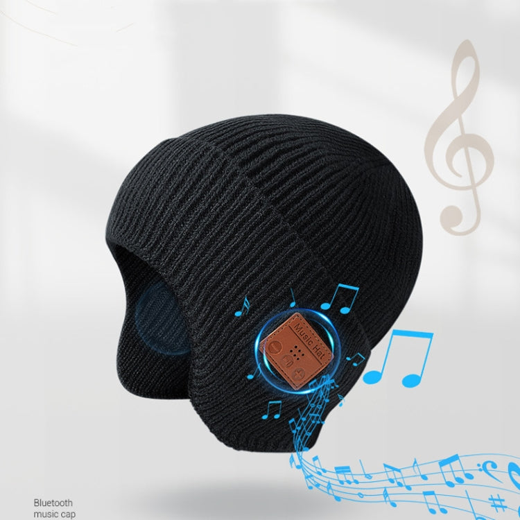 Black Bluetooth music hat with brown control patch and blue music-note accents