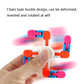 Hand holding colorful plastic finger spinner toy with rotating chain blocks