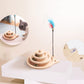 Wooden cat turntable scratcher on a base with feather wand and ball toys