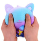 Scented squeeze cat toy held by hands, blue-purple gradient with pointed ears.