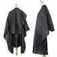 Black salon hair-dye cape with star speckle pattern, draped back and full coverage sleeves