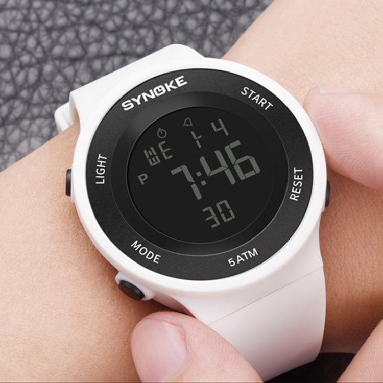 SYNOKE luminous LED watch on wrist with white strap and green digital display
