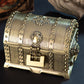 Bronze-toned metal double-layer jewel box with rivets and ornate front lock