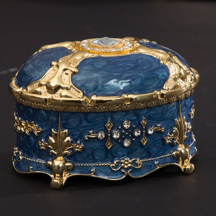 Gold-trim blue oval jewelry storage box with diamond-style top and floral side accents