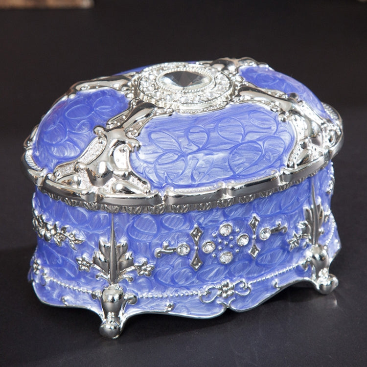 Silver-trim blue oval jewelry storage box with diamond-look bezel and embossed pattern lid
