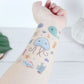 Marine animal tattoo stickers on arm with a blue whale, jellyfish, and starfish