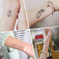 Small line-art temporary tattoo stickers on arms: anchor and feather