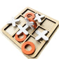 Wooden tic-tac-toe board with white X, gray O, and orange pieces laid out