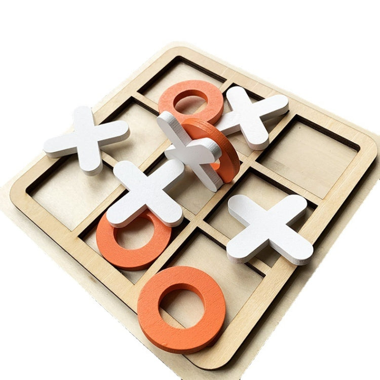 Wooden tic-tac-toe board with white X, gray O, and orange pieces laid out
