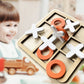 Wooden tic-tac-toe board with orange X and black O pieces ready to play