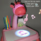 Pink dinosaur projector painting toy with glowing image on the drawing board