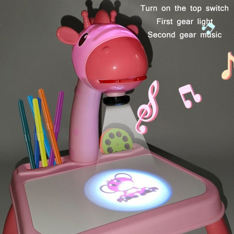 Pink dinosaur projector painting toy with glowing image on the drawing board