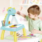 Blue dinosaur kids drawing and writing board with marker tray, crayons, and child using it