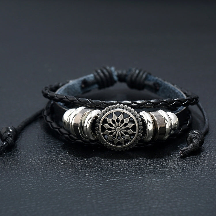 Black leather wrap bracelet with braided cord and central round floral charm in silver