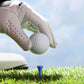 Golf ball teeing: gloved hand placing a blue plastic golf ball tee on the turf