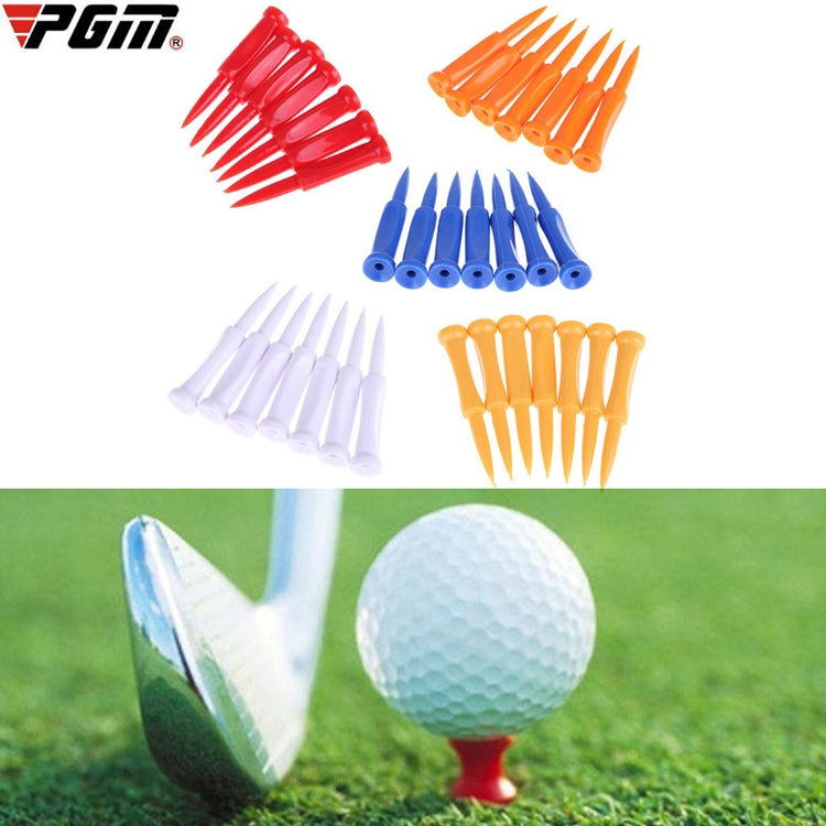 Assorted plastic golf ball tees in multiple colors, with golf ball on a red tee