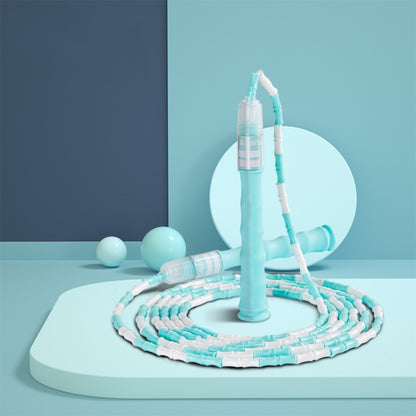 Blue and white bamboo-style PVC skipping rope, coiled with hand grips