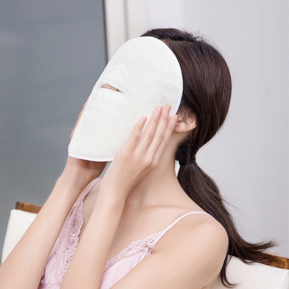 White plush facial compress towel mask with face opening, worn without visible straps