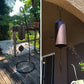 Bronze metal wind chime with bell-like top and hanging leaf clapper