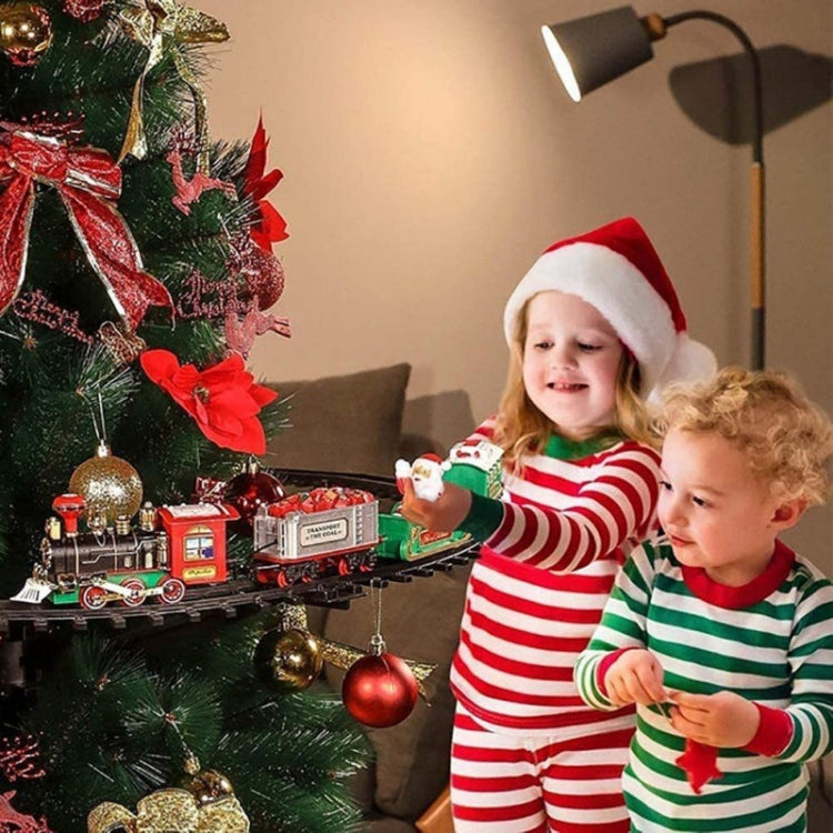 Christmas train rail car model on track with children holding holiday train cars