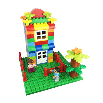 Colorful building block house set with trees and minifigures on a green baseplate