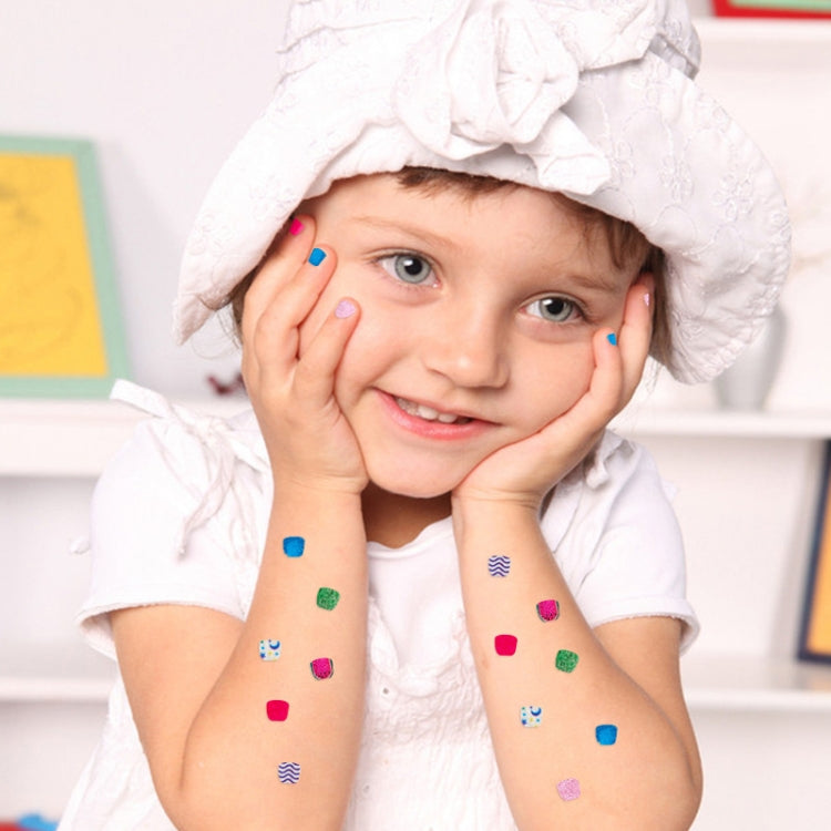 Child wearing colorful press-on nail stickers on hands