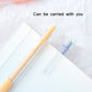 Orange and blue utility knife pens with clear blade sleeves angled over paper