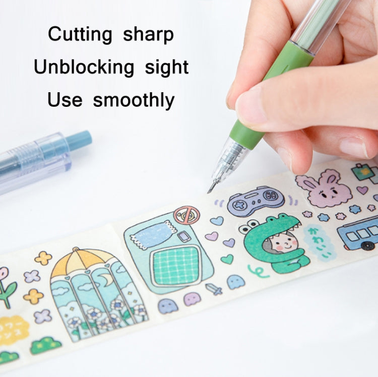 Hand holding green utility knife pen, blade tip cutting printed craft paper