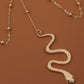 Gold-tone snake body chain with textured snake charm and ball-link chain loops