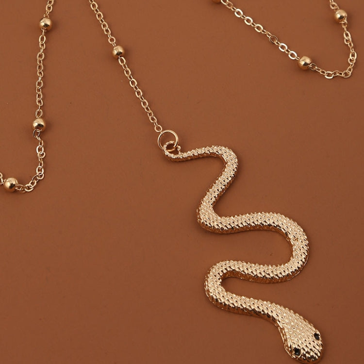Gold-tone snake body chain with textured snake charm and ball-link chain loops
