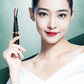 Heated electric eyelash curler held near face with black and rose-gold design