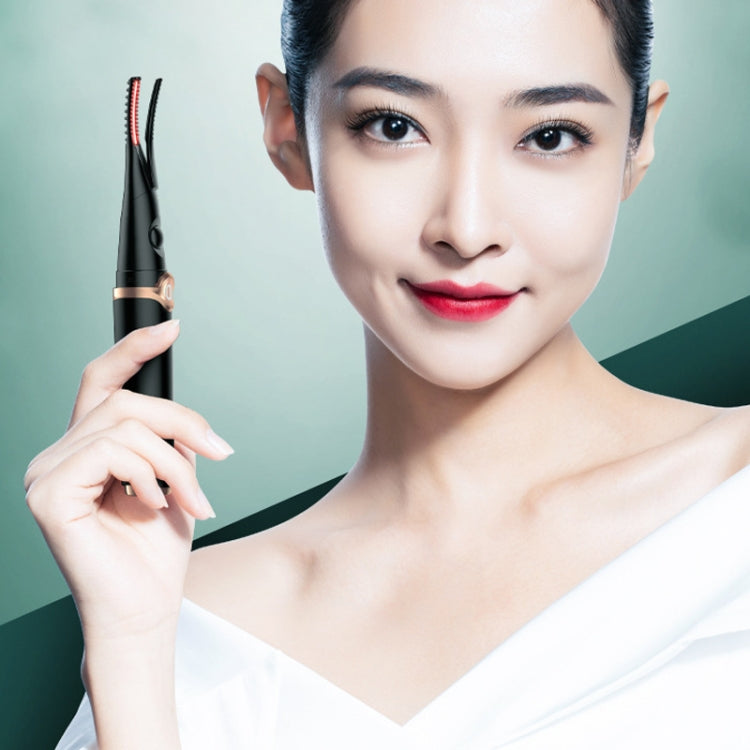 Heated electric eyelash curler held near face with black and rose-gold design