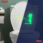 Toilet seat wall sticker glowing green at night, with bunny and quote