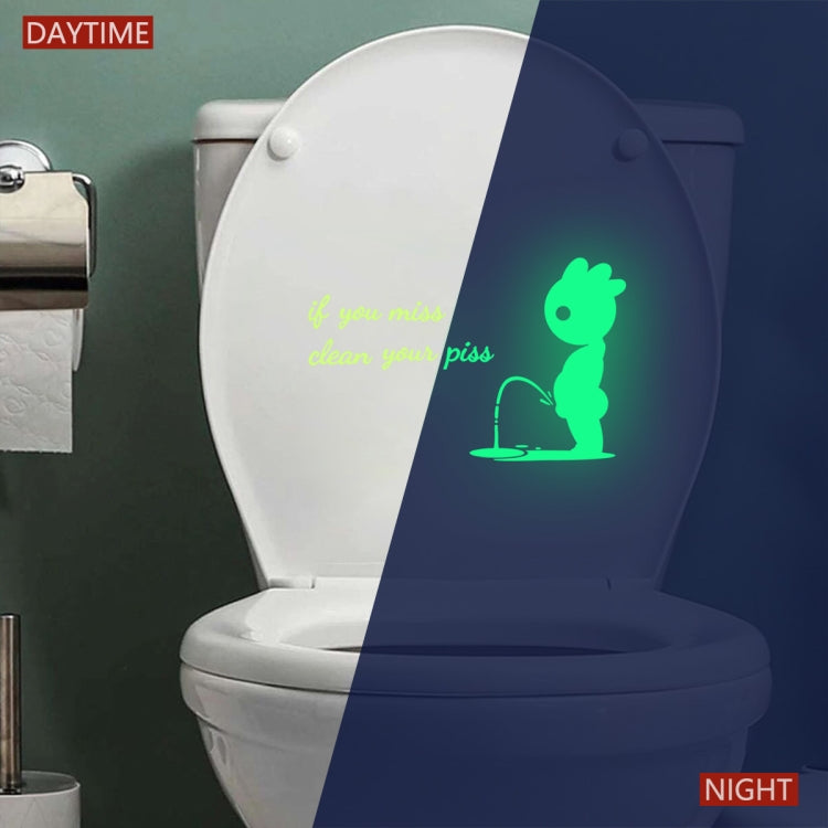 Toilet seat wall sticker glowing green at night, with bunny and quote