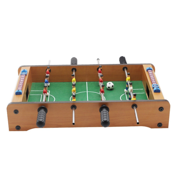 Mini wooden foosball table with green pitch and player figures on control rods