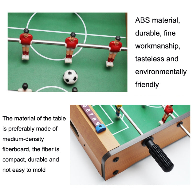 Close-up of foosball player figures and green playing field on a mini wooden table