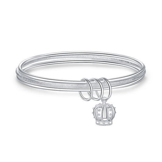 Silver three-ring bracelet with crown charm and triple loop closure, front view.