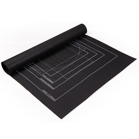 Black felt jigsaw puzzle organizer mat with printed grid guide lines, partially rolled