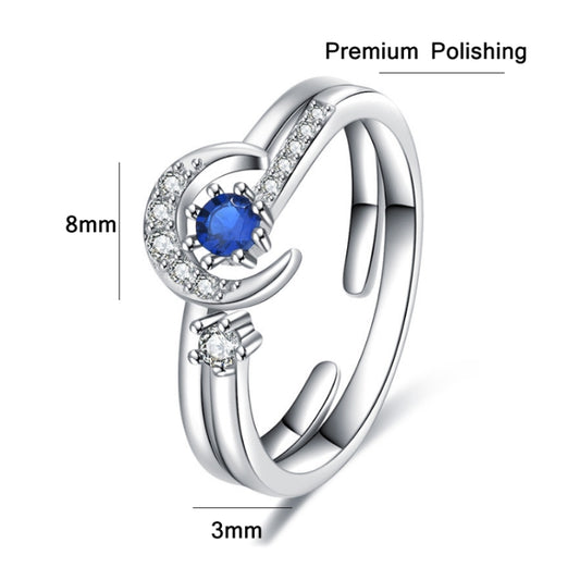 Silver-tone open ring with stacked star and moon details, blue center stone and clear crystals