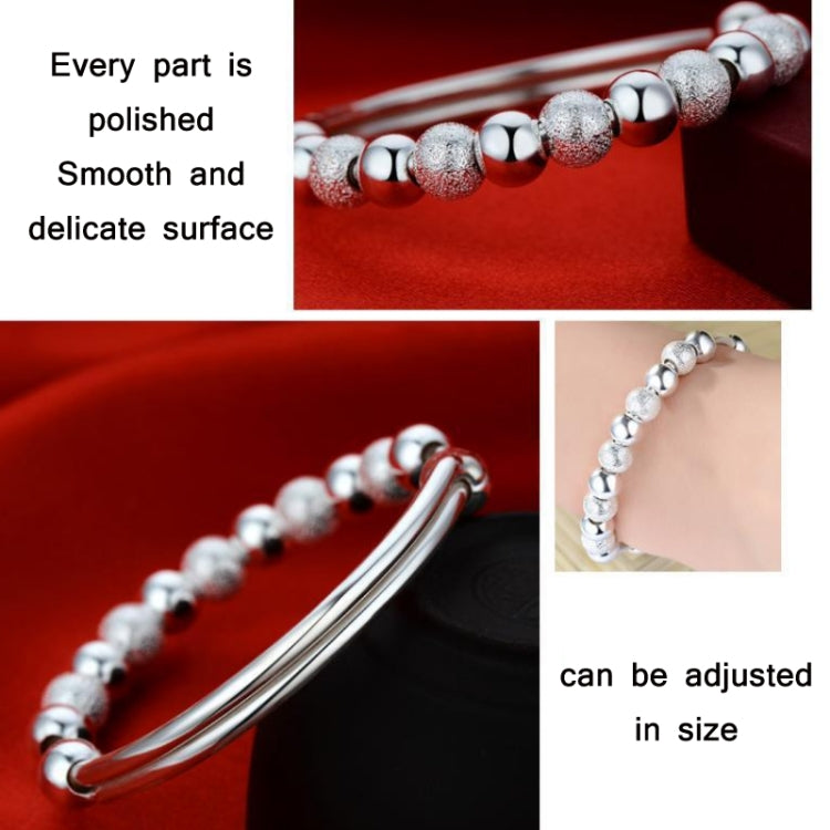 Silver-tone beaded bracelet with smooth round beads and hinged cuff design
