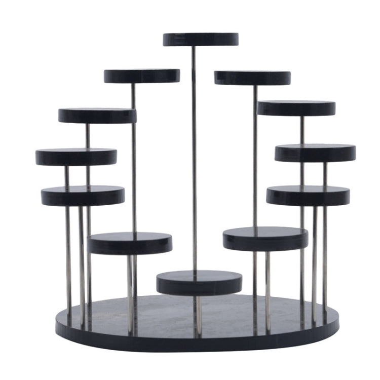 Black acrylic ring display stand with round black pegs on clear vertical rods