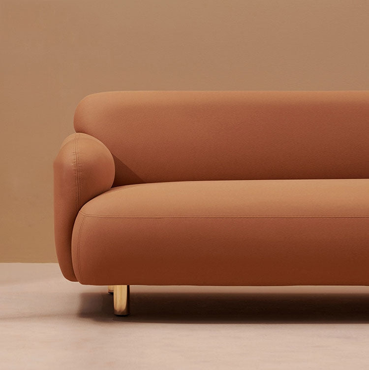 Upholstered sofa with stainless steel support legs, visible front base and foot