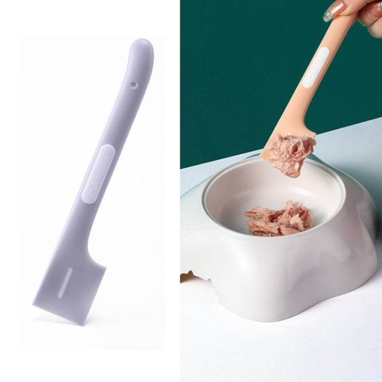 Grey long-handled cat-shaped spoon mixing wet pet food in a metal bowl.