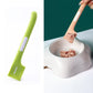 Fruit green long-handled cat-shaped spoon mixing wet pet food in a metal bowl.