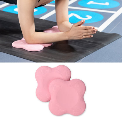 Pink flat yoga elbow and knee support pads, shown in use on a mat
